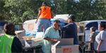 Delegates Vince James and Brenda Jesus conduct relief distribution for returning families of the Oak Ridge Fire